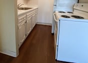 Thumbnail 22 of 27 - an empty kitchen with white appliances and white cabinets