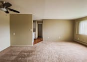 Thumbnail 2 of 27 - an empty living room with a ceiling fan and carpet