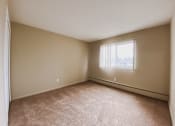 Thumbnail 6 of 27 - an empty bedroom with a window and carpeting