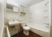 Thumbnail 7 of 27 - a bathroom with a toilet and a sink and a bath tub