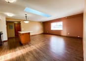 Thumbnail 3 of 18 - an empty living room with wood floors and a table