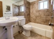 Thumbnail 12 of 18 - a bathroom with a toilet and a sink and a bath tub