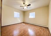 Thumbnail 13 of 18 - an empty bedroom with wood floors and a ceiling fan