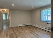 Thumbnail 31 of 32 - A room with wooden flooring and a window.