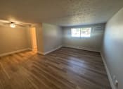 Thumbnail 25 of 32 - A room with wooden flooring and a window.