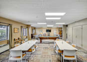 Thumbnail 12 of 30 - A conference room with a long table and chairs at Independence Place Apartments, Parma Heights, Ohio