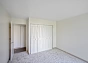 Thumbnail 27 of 30 - A room with white cupboards and a grey carpet at Independence Place Apartments, Parma Heights