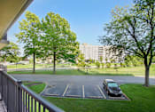 Thumbnail 4 of 30 - A car is parked in a parking lot at Independence Place Apartments, Parma Heights, Ohio