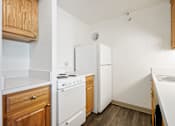 Thumbnail 20 of 30 - A kitchen with a white stove and white refrigerator at Independence Place Apartments, Parma Heights, OH