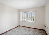 Thumbnail 26 of 30 - A room with a window covered by white blinds at Independence Place Apartments, Parma Heights, OH