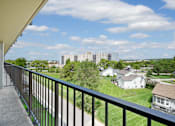 Thumbnail 30 of 30 - A balcony overlooks a residential area with houses and apartment buildings at Independence Place Apartments, Ohio
