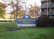 Thumbnail 3 of 30 - A sign for Independence Place stands in a grassy area at Independence Place Apartments, Parma Heights