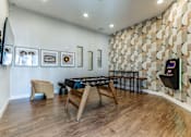 Thumbnail 9 of 17 - A room with a wooden floor and a wall with a patterned design.