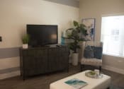 Thumbnail 6 of 75 - a living room with a tv and a chair at The Crossings at Redlands, Redlands, CA, 92374