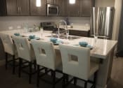 Thumbnail 22 of 75 - a kitchen with a large island with a marble countertop at The Crossings at Redlands, Redlands, CA, 92374