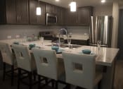 Thumbnail 61 of 75 - a kitchen with a large island with a marble countertop at The Crossings at Redlands, Redlands, CA