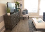 Thumbnail 28 of 75 - a living room with a tv and a chair at The Crossings at Redlands, Redlands, CA