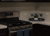 Thumbnail 27 of 75 - a kitchen with a stove top oven next to a counter at The Crossings at Redlands, Redlands, CA, 92374