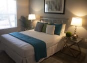 Thumbnail 31 of 75 - a bedroom with a bed and two lamps  The Crossings at Redlands, California, 92374