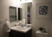 Thumbnail 54 of 75 - a small bathroom with a sink and a toilet at The Crossings at Redlands, Redlands, California
