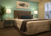 Thumbnail 39 of 75 - a bedroom with a green accent wall and a bed with a brown headboard at The Crossings at Redlands, California