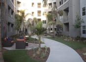 Thumbnail 19 of 75 - a walkway through the courtyard at the flats at big tex apartments in san antonio at The Crossings at Redlands, Redlands, CA, 92374