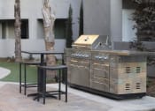 Thumbnail 53 of 75 - an outdoor kitchen with a grill and a table and chairs at The Crossings at Redlands, Redlands, 92374