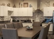 Thumbnail 17 of 75 - a kitchen with white cabinets and a wooden table with a bowl of eggs on it at The Crossings at Redlands, California