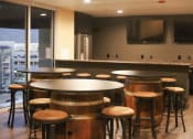 Thumbnail 35 of 75 - a bar area with stools and tables at The Crossings at Redlands, California, 92374