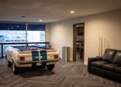 Thumbnail 37 of 75 - a pool table sits in the middle of a room with a couch and chair at The Crossings at Redlands, California, 92374