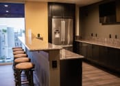 Thumbnail 20 of 75 - a kitchen with granite countertops and stainless steel appliances at The Crossings at Redlands, Redlands