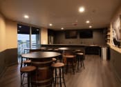Thumbnail 24 of 75 - a bar area with stools and tables at The Crossings at Redlands, Redlands