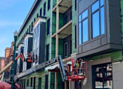 Thumbnail 12 of 16 - A building under construction with scaffolding and a crane at Sol Apartments, Troy, 12180