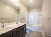 Thumbnail 6 of 13 - Bathroom with Double Sinks at Stone Springs Apartments, Virginia