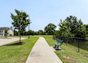 Thumbnail 8 of 10 - A park with a bench and a fence at Carriage Hills, Lumberton