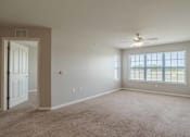 Thumbnail 5 of 10 - A room with a ceiling fan and a door at Carriage Hills, Lumberton, 28358