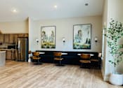 Thumbnail 11 of 23 - A modern kitchen with a dining area and a living room.
