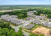 Thumbnail 22 of 23 - A bird's eye view of a residential area with houses and trees.