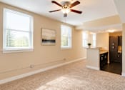 Thumbnail 2 of 17 - A room with a ceiling fan and a painting on the wall.
