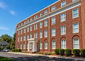 Thumbnail 14 of 17 - A red brick building with white trim and windows.
