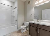 Thumbnail 6 of 10 - A white bathroom with a toilet, sink, and bathtub. at Killian Terrace Apartments, Columbia