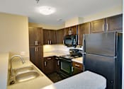 Thumbnail 11 of 17 - Kitchen with a sink, stove, and refrigerator at Highland Memorial, Gastonia, 28052