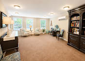 Thumbnail 12 of 17 - A living room with a carpeted floor and furniture.