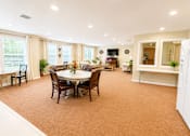 Thumbnail 16 of 17 - A dining room with a table set for six people.
