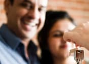 Thumbnail 2 of 3 - A Person is Handing Over a Key at Colonel Bluffs Apartments, Columbia, SC