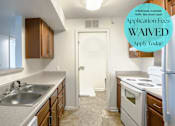 Thumbnail 11 of 11 - A kitchen with a sign that says "Application Fees WAIVED".