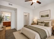 Thumbnail 8 of 27 - A bedroom with a large bed and a ceiling fan.