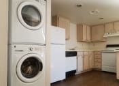 Thumbnail 13 of 23 - In-unit washer and dryer and kitchen at university west apartments in flagstaff az