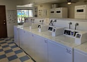 Thumbnail 12 of 16 - A row of sinks in a public washroom.