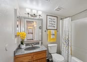 Thumbnail 17 of 24 - A bathroom with a mirror, sink, toilet, and a sign that says "Today is a good day to be kind.".
